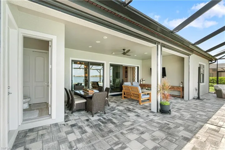 View of patio featuring a lanai, an outdoor living space, and ceiling fan