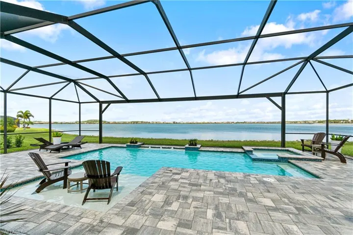 View of pool with a patio, an in ground hot tub, and a lanai