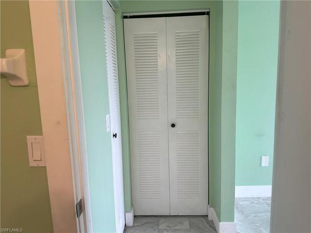 Primary bath looking toward linen closet.
