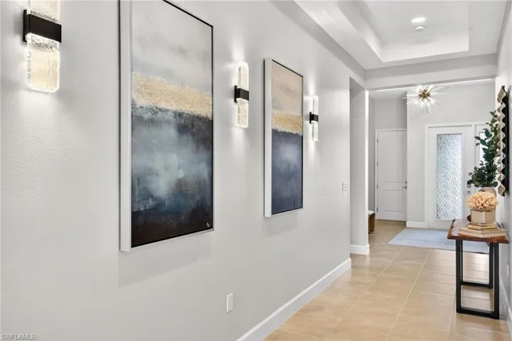 Other side of hall features three chic sconces to illuminate your way to the pool area!