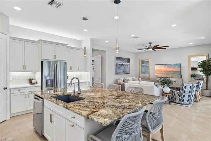 Shot from the dining area into the kitchen looking out into the great room. LOVE, LOVE, LOVE!