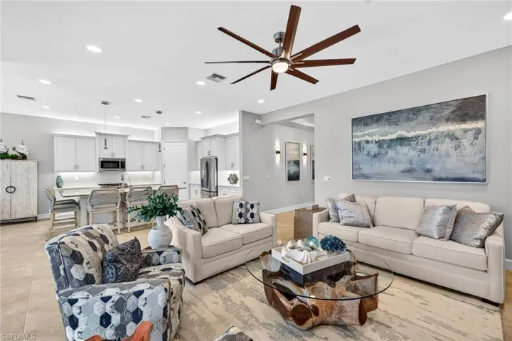 View into kitchen w/ island that seats 5, under and over counter lighting, and gas cooking!
