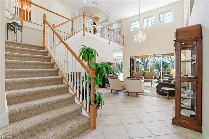 Stairs lead to loft overlooking living area.