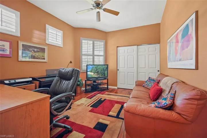 Office space featuring ceiling fan and light hardwood / wood-style floors