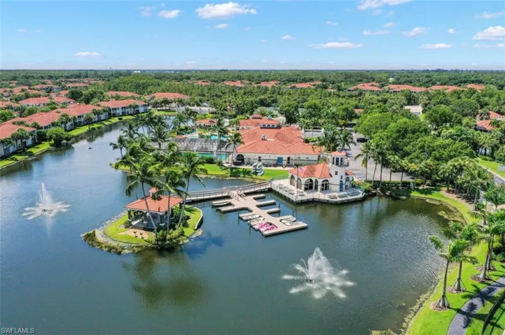 Birds eye view of property with a water view