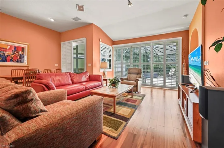 Living room featuring vaulted ceiling and light hardwood / wood-style floors