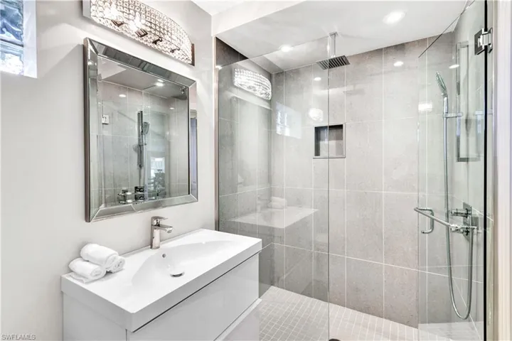 Bedroom and Pool Bathroom with vanity and an enclosed shower