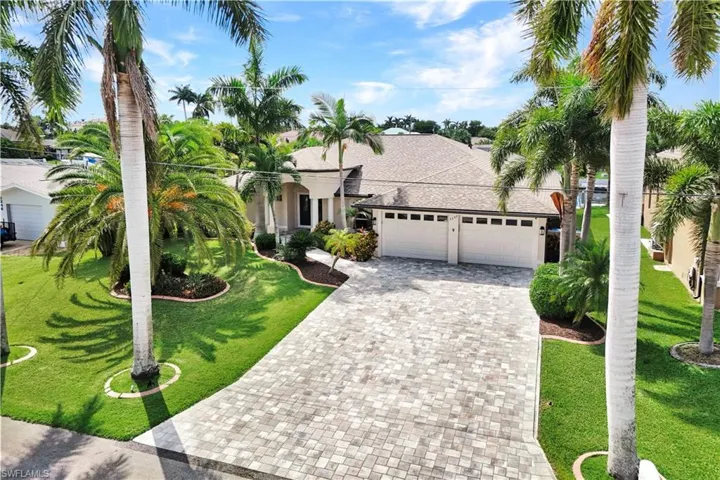 View of front of home featuring a front yard and a garage