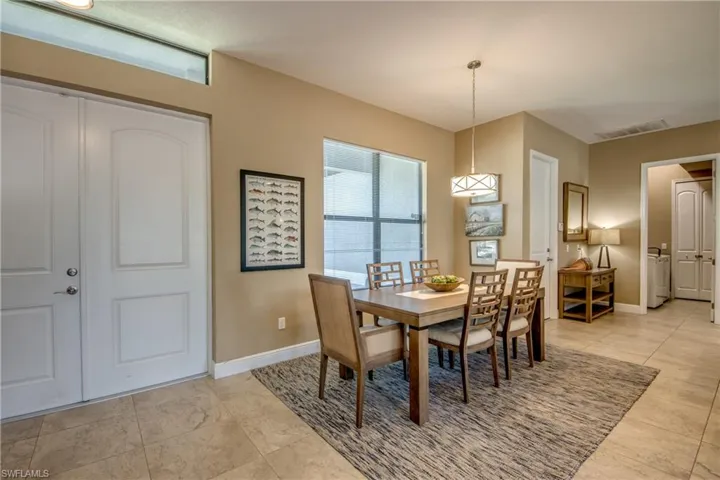 Dining space with light tile patterned flooring