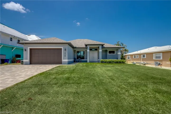 View of front facade with a front yard and a garage