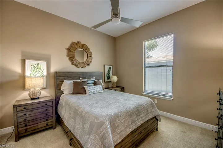 Carpeted bedroom with ceiling fan