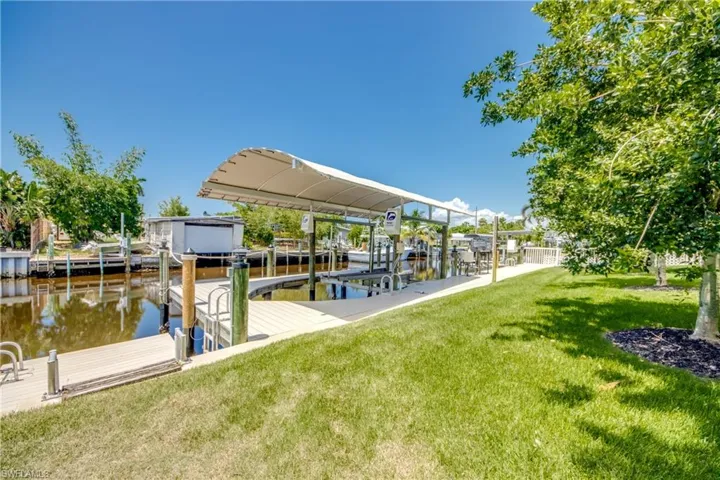 View of dock featuring a water view and a yard