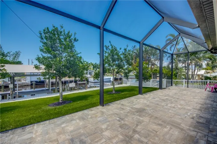 Unfurnished sunroom with lofted ceiling and a water view