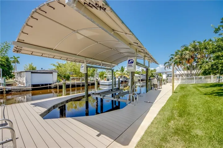 View of dock featuring a water view and a yard