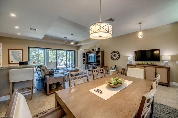 Tiled dining space with a tray ceiling
