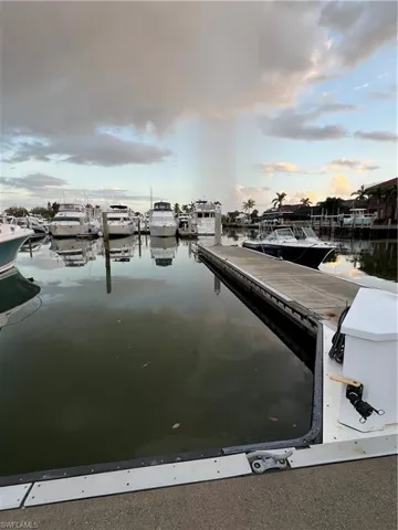 Dock area with a water view and view of marina