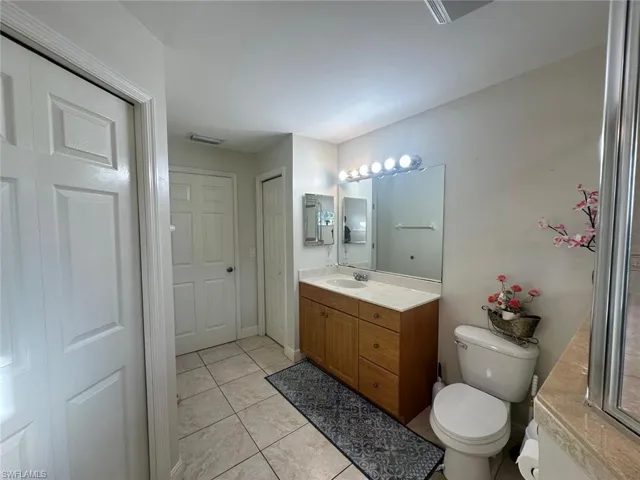 Primary Bathroom with tile patterned flooring, vanity, and toilet
