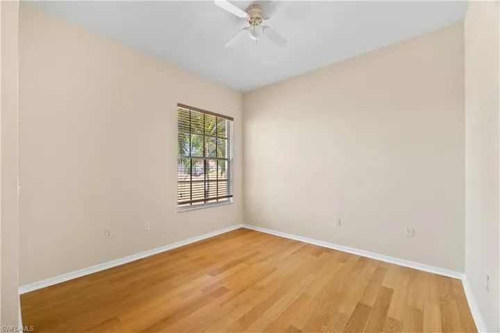 Unfurnished room with ceiling fan and light hardwood / wood-style flooring