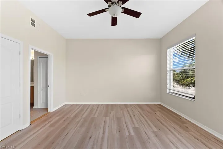 Unfurnished room featuring ceiling fan and light wood-type flooring