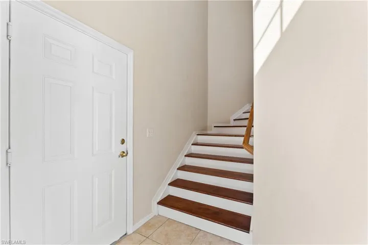 Stairway with light tile flooring