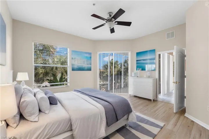 Virtually Staged Bedroom with ceiling fan and light wood-type flooring