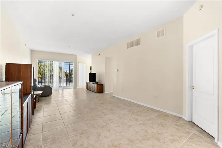 Unfurnished living room with light tile flooring