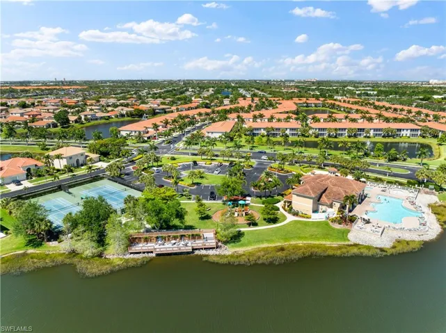 Birds eye view of property with a water view