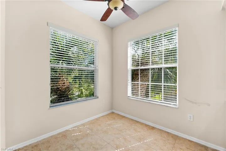 Empty room featuring plenty of natural light, ceiling fan, and light tile floors