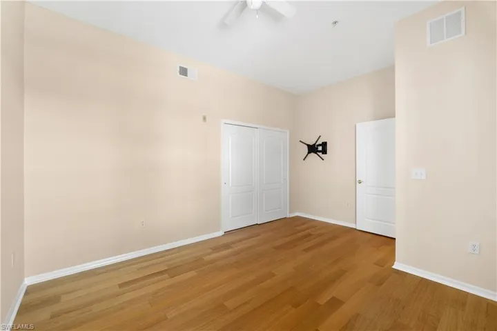 Unfurnished room with ceiling fan and light hardwood / wood-style floors