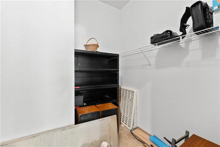 Spacious closet featuring light tile floors