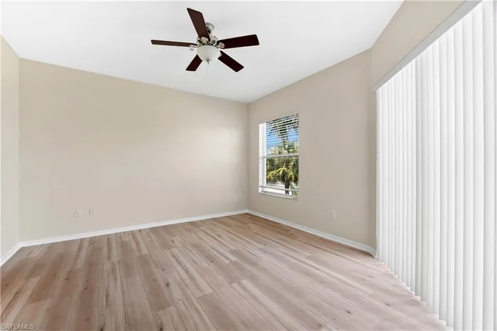 Unfurnished room with light wood-type flooring and ceiling fan