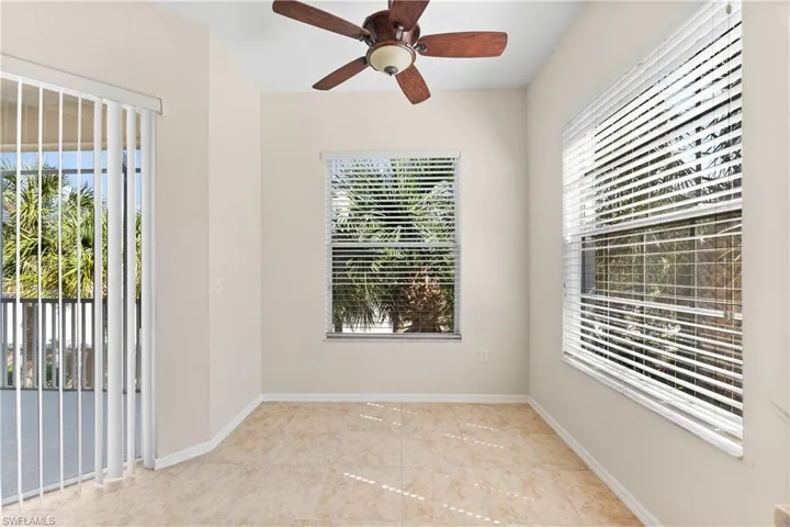Spare room with ceiling fan and light tile floors
