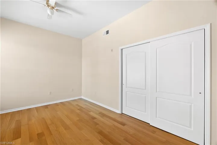 Unfurnished bedroom featuring a closet, ceiling fan, and light wood-type flooring