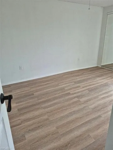 Unfurnished bedroom with light wood-style floors and a closet