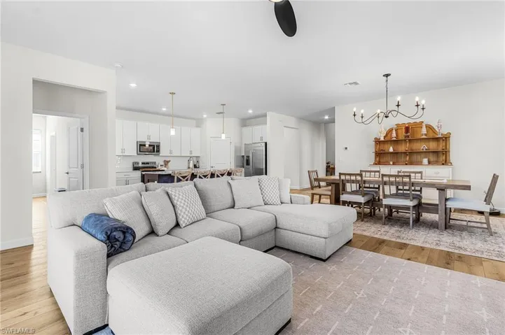Living area featuring recessed lighting, light wood-type flooring, and a chandelier