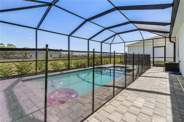 Swimming pool with a sunroom, a lanai, and a patio area