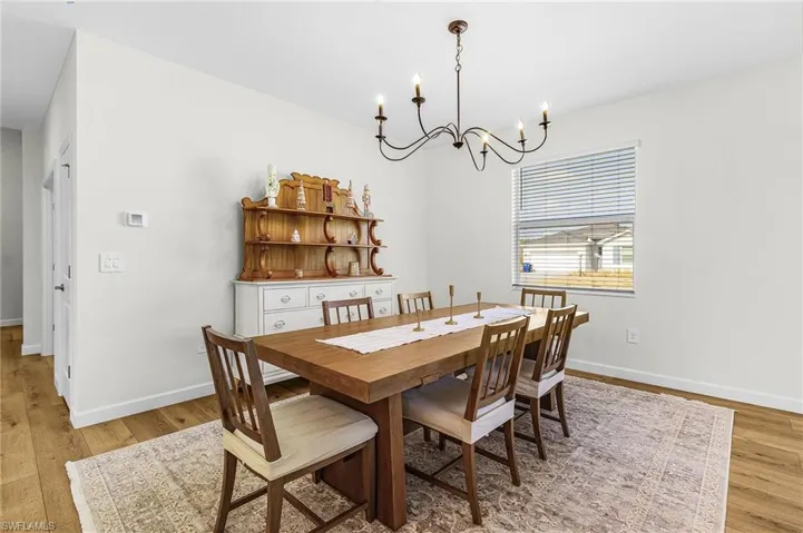 Dining room featuring light wood-style flooring and a chandelier