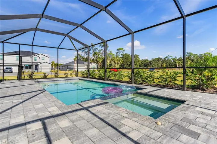 View of pool with a sunroom, a lanai, and a pool with connected hot tub