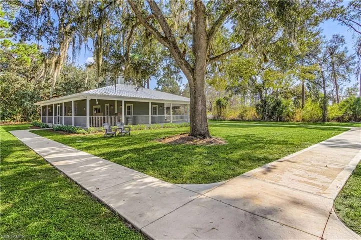 View of front of property with a front lawn and a metal roof