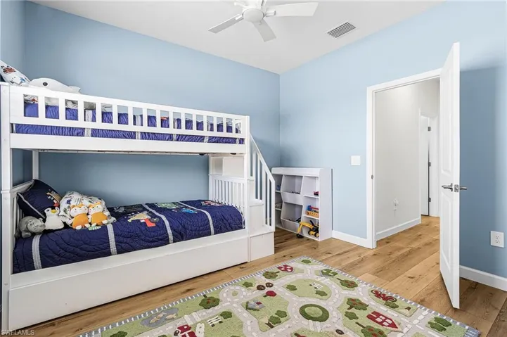 Bedroom with light wood-style floors and ceiling fan