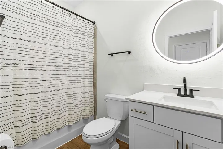 Full bath with vanity and shower / bath combo