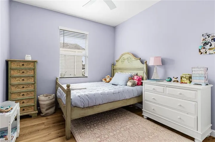 Bedroom with light wood-style flooring and a ceiling fan