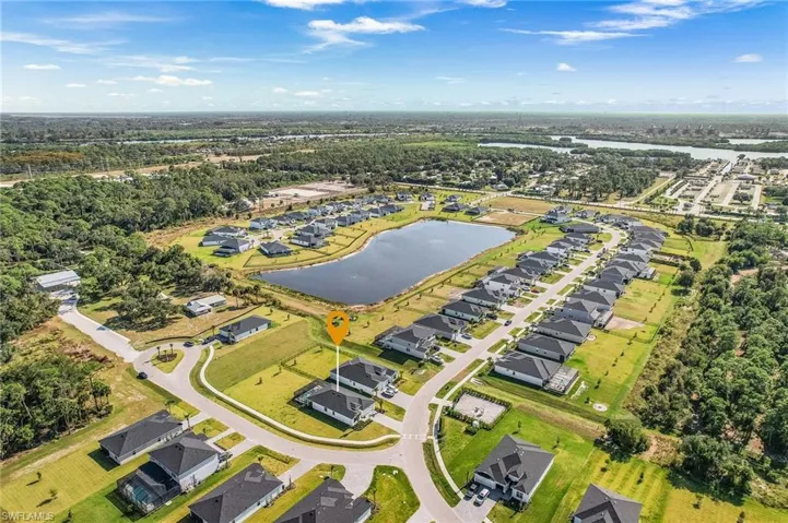 View of property location featuring a nearby body of water and nearby suburban area