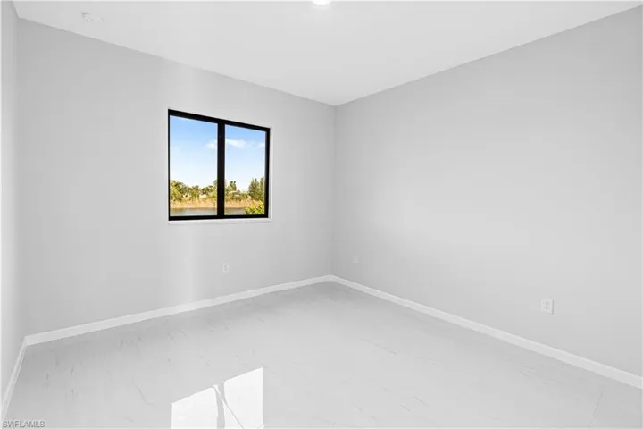 Empty room featuring baseboards