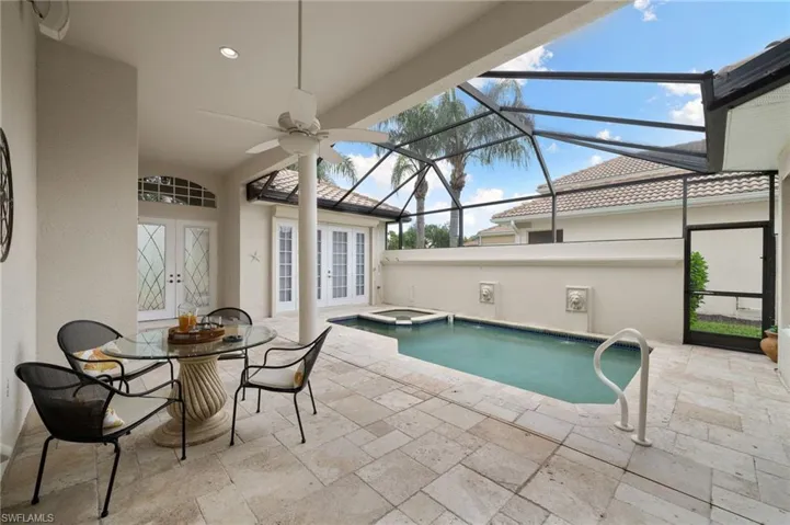 View of swimming pool with a patio area, ceiling fan, an in ground hot tub, private courtyard lanai, and french doors with surround sound