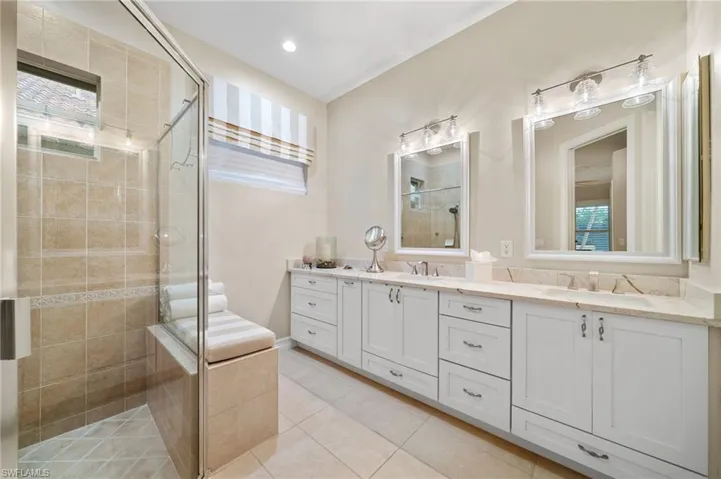Bathroom with a healthy amount of sunlight, tile patterned floors, and double sink vanity