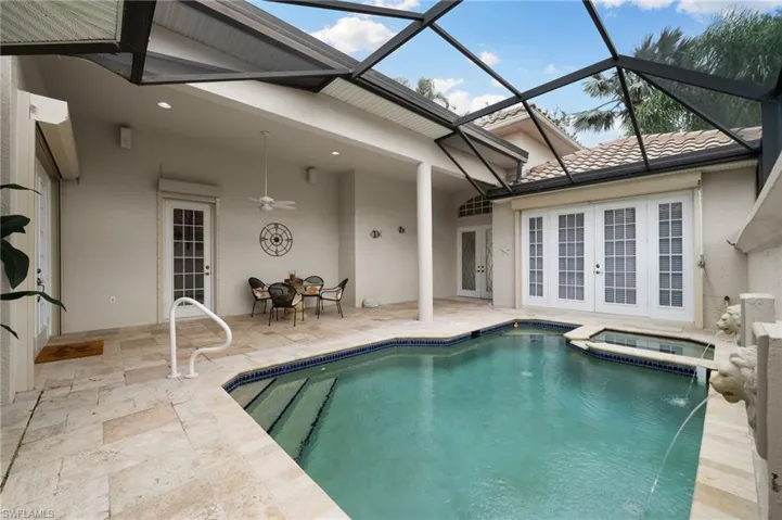 View of pool featuring an in ground hot tub, a patio, french doors, and a lanai
