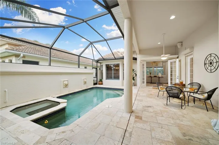 View of swimming pool featuring a lanai, a patio, an in ground hot tub, and ceiling fan