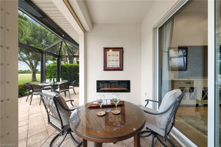 Outdoor covered sitting area with fireplace feature