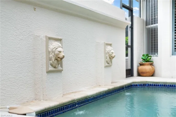 View of swimming pool with pool water feature